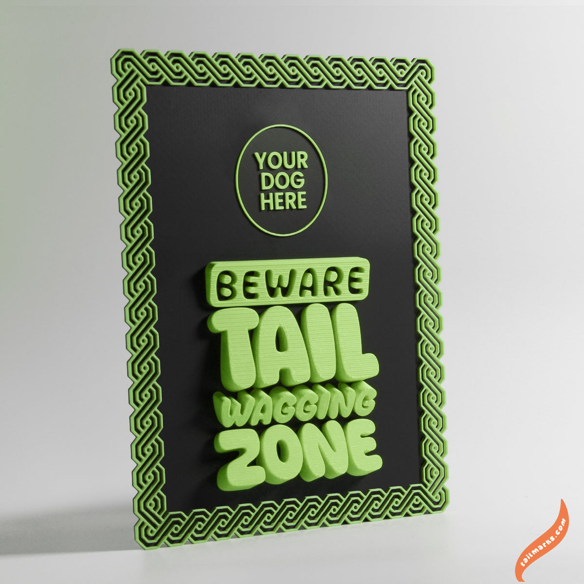 Decorative sign with green text 'Beware Tail Waving Zone' and a maya green frame on a black background.