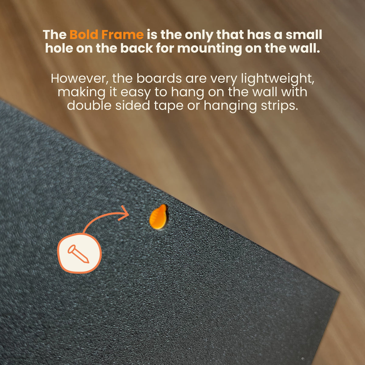 Text on a black board with mounting instructions and a small hole for wall mounting.